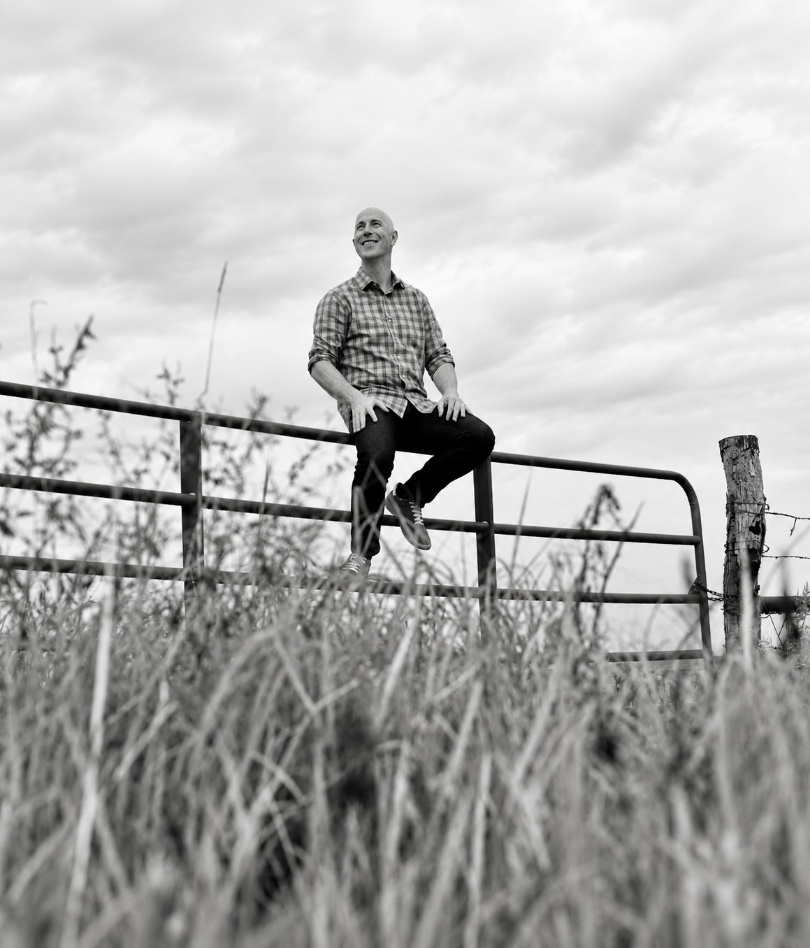 Vaughn Kohler sitting on a pasture gate